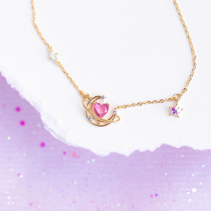 Our Lovesick Necklace is not for the faint of heart. This necklace pairs perfectly together with our Lovesick Dangle Earrings to give you a look that is out of this world! 18k gold plated, 18k rose gold plated, or rhodium plated over brass with a protective coating Cubic zirconia stones. Gradient stones may vary in hues of pink, purple and blue. 16" chain with a 2" extension Shop our entire Gradient Stones Collection here Whimsical Sterling Silver Jewelry For Party, Cute Heart Shaped Clavicle Chain Jewelry, Whimsical Dangle Moon Charm Jewelry, Whimsical Moon Charm Dangle Jewelry, Whimsical Gold Jewelry With Heart Charm, Whimsical Dangle Jewelry With Moon Charm, Cute Heart Shaped Clavicle Chain, Cute Heart-shaped Clavicle Chain, Cute Pendant Jewelry Gift For Her