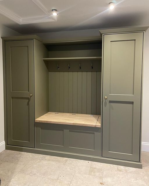 an empty bench in the middle of a room with two doors open to reveal another area