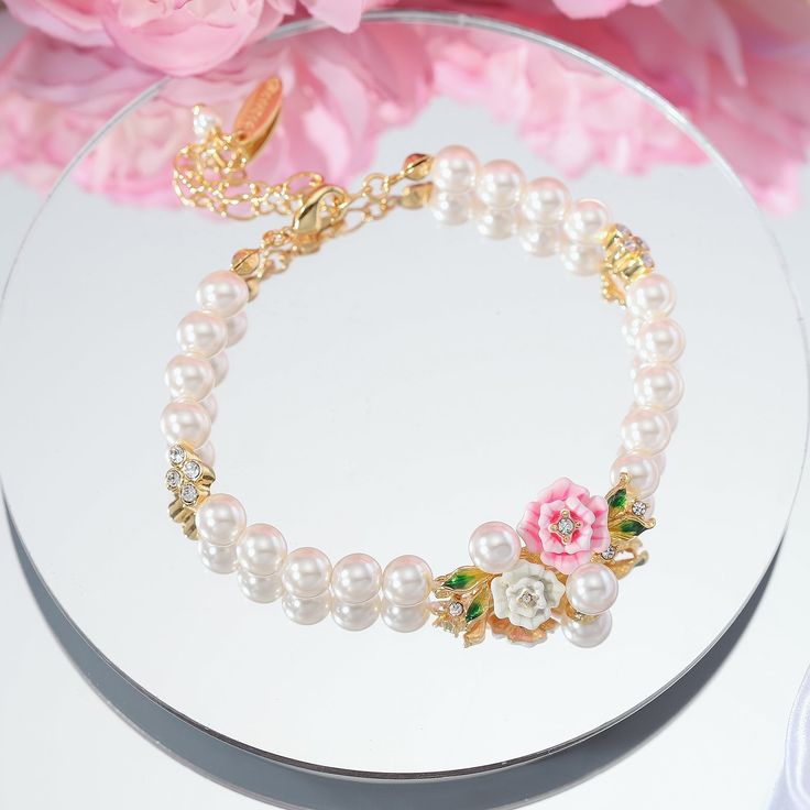 Adorn your wrist in natural elegance with the Wild Rose Pearl Bracelet. Delicate pink roses, each petal intricately engraved, entwine to form the band encasing shimmering freshwater pearls. Enamel in rich shades of green leaf and rosy floral hues brings the English countryside to mind. Light and lovely, this piece offers far more than meets the eye with its carefully crafted floral charm. Subtle and sweet, it brings beauty and delight to every occasion. DETAILS Plating: 18K Gold Materials: 18K G More Than Meets The Eye, Luxe Jewelry, Enamel Bracelet, Wild Rose, Enamel Flower, English Countryside, Flower Bracelet, Wild Roses, Nature Bracelets