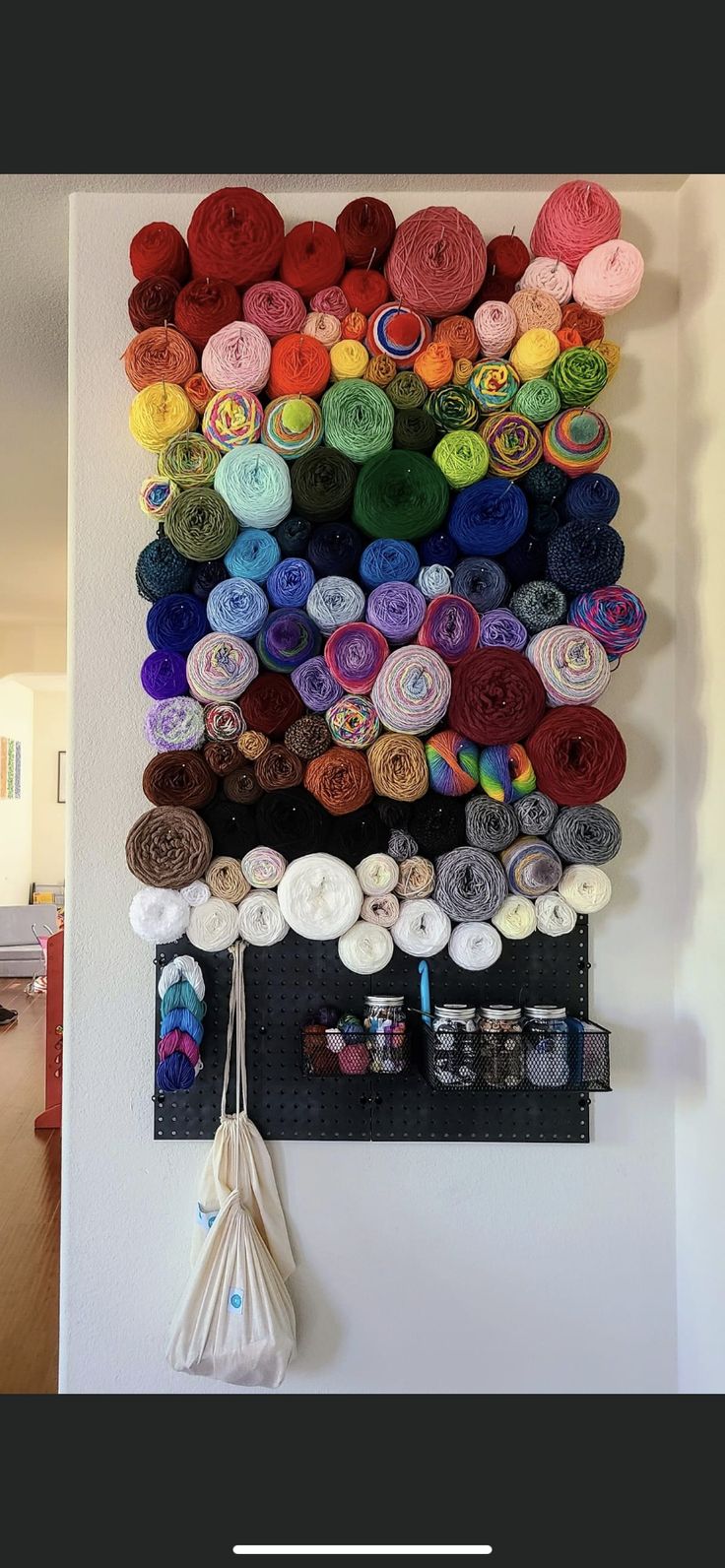 there is a wall hanging with yarn on it