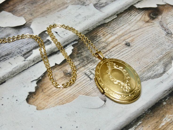 This gold oval locket necklace is a great keepsake necklace. It opens for your favorite two photographs. You will need to find a photo that fits and glue it into place. We do not place the photo in for you and at this time we do not engrave. It's the perfect gift for all ages. These lockets are not vintage, they are new. Unfortunalty it is very difficult to find vintage lockets. I T E M • DETAIL: - PENDANT SIZE: Outside measurements 7/8" x 1 1/4", Inside measurement 5/8 x 7/8 - CHAIN LENGTH: 16" Heirloom Locket Necklace With Oval Pendant For Anniversary, Heirloom Oval Pendant Locket Necklace For Anniversary, Heirloom Style Oval Pendant Locket Necklace With Vintage Charm, Heirloom Oval Pendant Locket Necklace For Memorial, Gold Engraved Oval Cabochon Necklace, Yellow Gold Oval Pendant Locket Necklace For Memorial, Yellow Gold Oval Locket Necklace For Memorial, Heirloom Yellow Gold Oval Pendant Locket Necklace, Gold Oval Necklace For Anniversary Gift