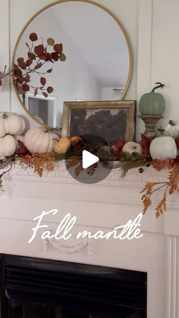 a fireplace mantel decorated with fall decorations