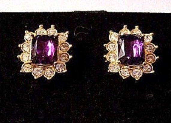 Avon purple clear amethyst square shape faceted center stone clip on earrings vintage gold tone smooth metal finish accent edge raised nail heads round bezel set rhinestones. In excellent vintage condition. Measures 1/2 of an inch wide 3/4 of an inch long. Formal Purple Clip-on Jewelry, Elegant Purple Clip-on Earrings For Formal Occasions, Purple Clip-on Earrings For Formal Occasions, Monet Earrings, Short Hills, Costume Earrings, Avon Jewelry, Earrings Vintage, Scalloped Edge