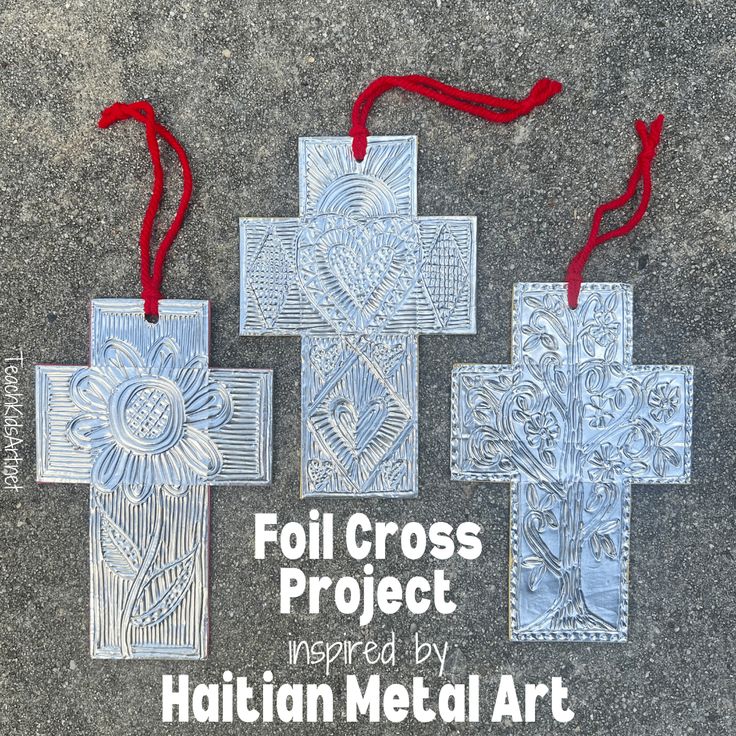 four metal cross ornaments with red string hanging from them