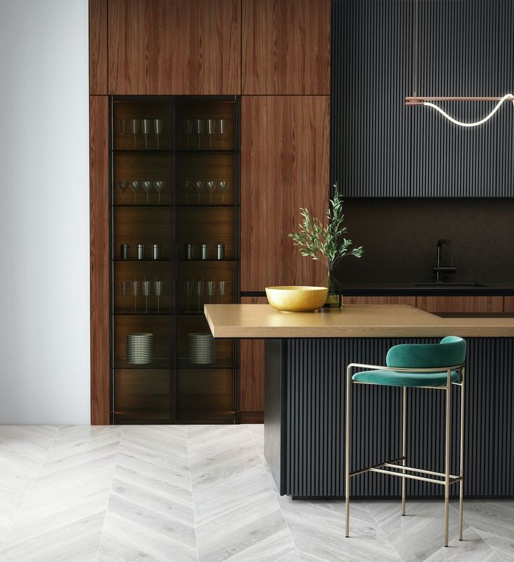 a kitchen with an island and bar stools next to it, in the middle of a room