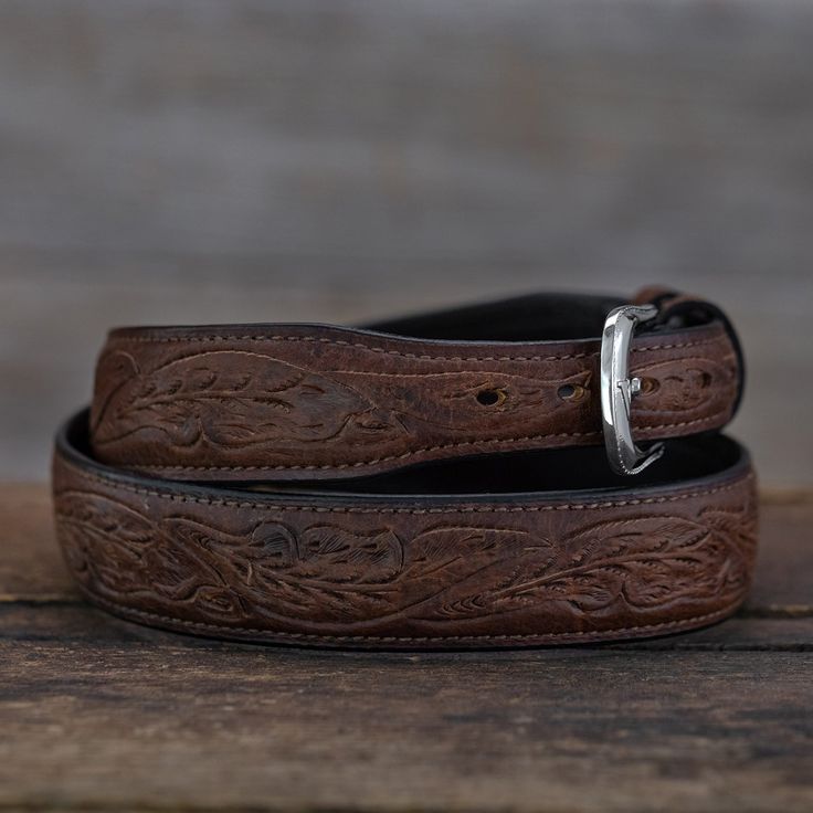 A beautiful belt that subtly combines western tooling with an oiled American Bison pull-up leather. Normally this type of oiled leather is only found with a completely smooth surface, but our master leather craftsmen are able to delicately carve our running oak leaf pattern into each. The resulting look gives it a warm, distressed vibe. Each belt is fully hand tooled and made of genuine American Bison. Like all belts our tooled bison is lined in top grain leather and accented with fine stitched Oak Leaf Pattern, Leaf Belt, Dr Closet, American Bison, Leather Craftsmen, Beautiful Belts, Western Belts, Oak Leaf, Sterling Silver Mens