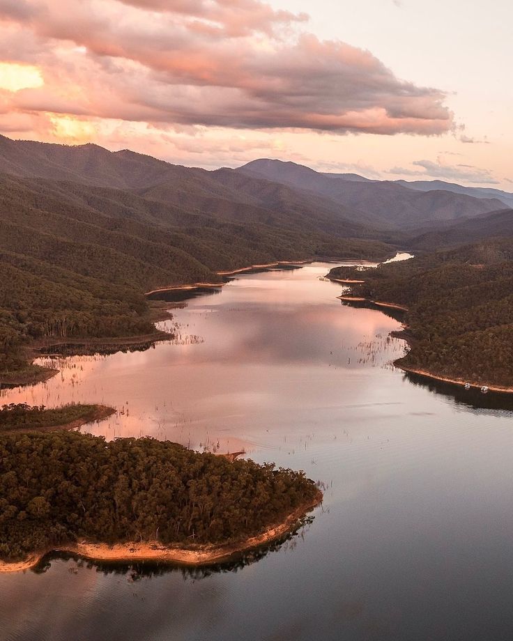 an aerial view of a lake surrounded by mountains