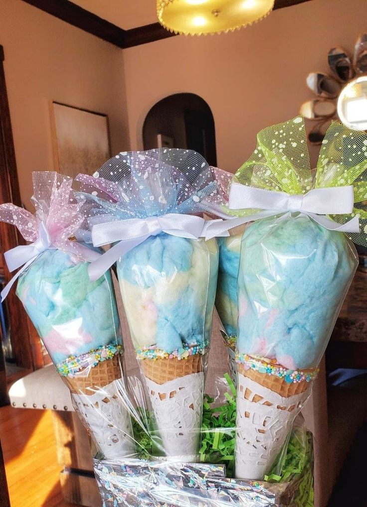 three ice cream cones wrapped in cellophane and sitting on top of each other