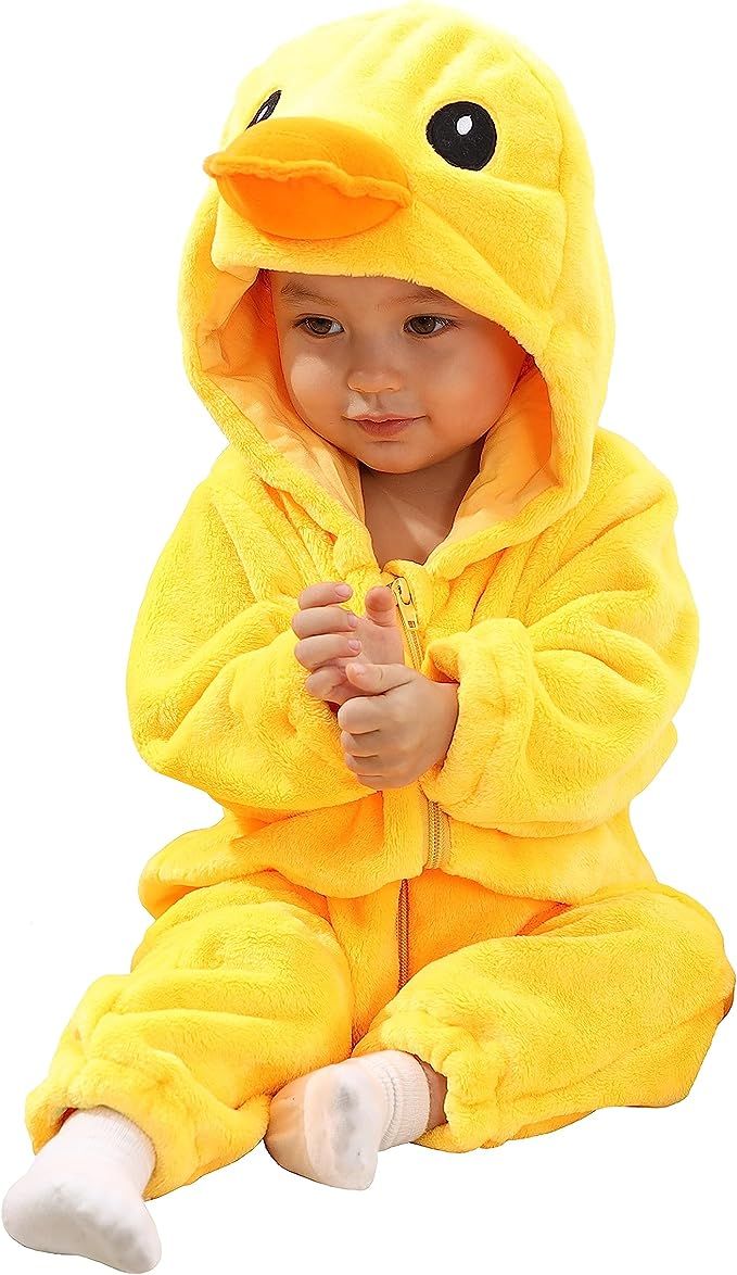 a baby in a yellow duck costume sitting on the floor with his hands folded up