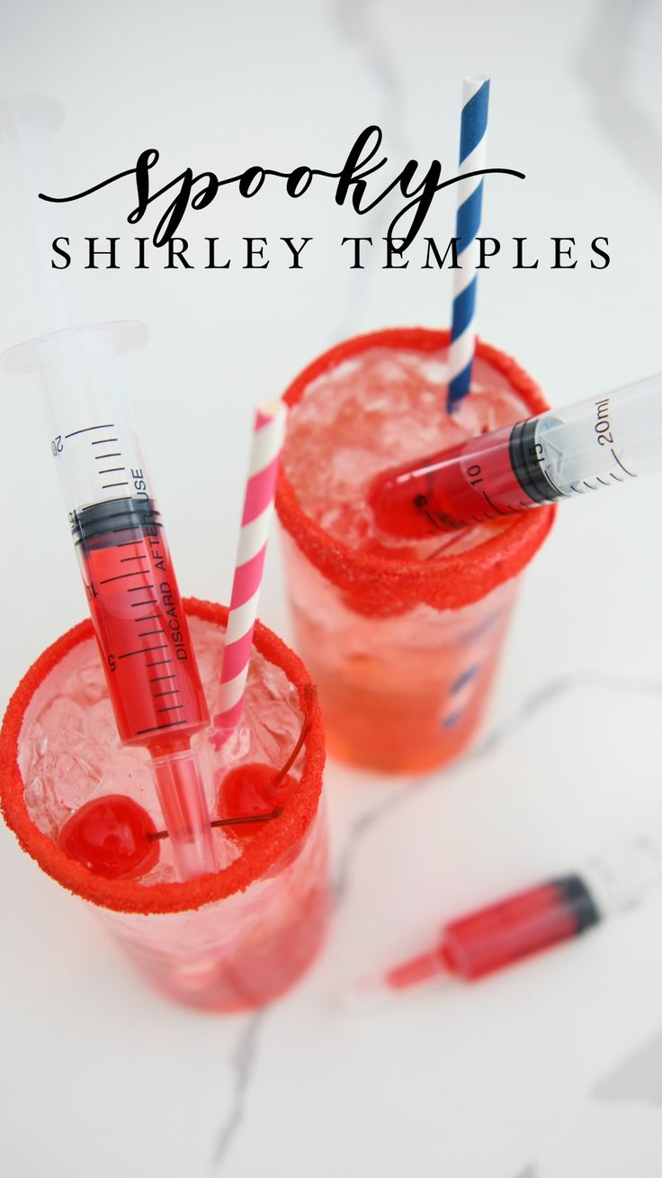 two glasses filled with red liquid and straws