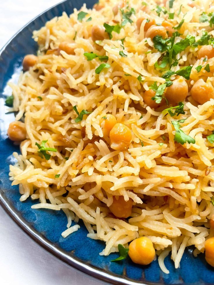 a blue plate topped with rice and chickpeas