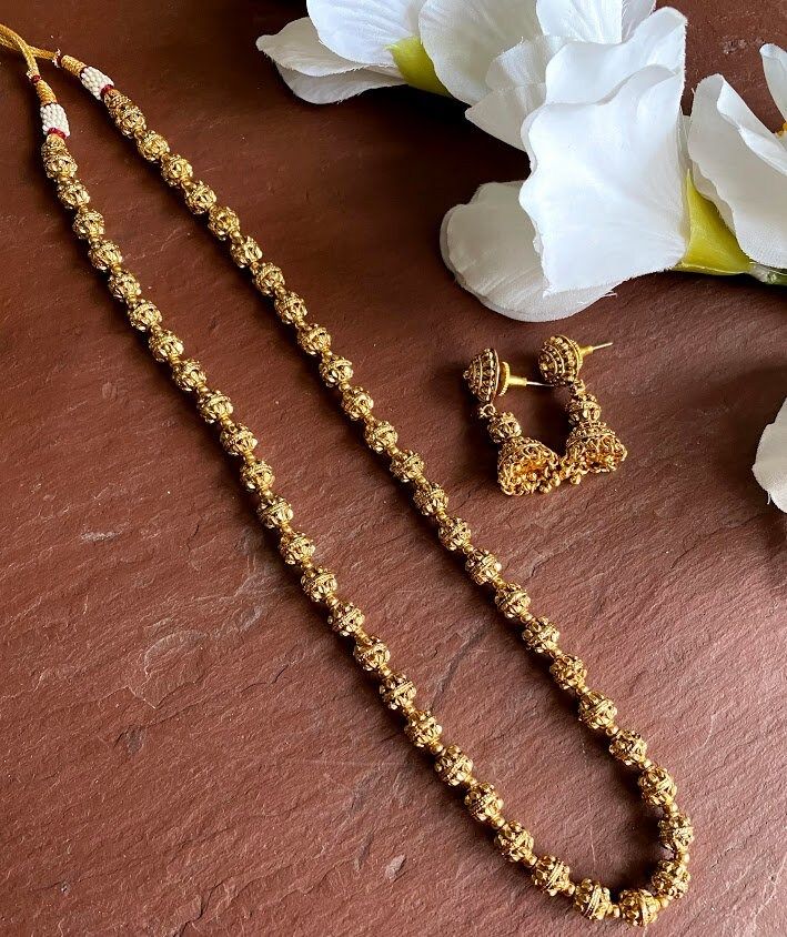 24 K gold plated beaded long necklace with matching delicate earrings Highest quality and craftsmanship Indian Bridal Traditional One Gram Jewelry Necklace Set. 3 line Length : 16 inches 2 line Length: 24 inches 1 line Length : 30 inch All the raw material used in this product is of high quality and is handcrafted with love. Premium Quality and High craftsmanship 100% Satisfaction Guarantee: Long Lasting Plating, High-Quality Stones. Gifting: This pair of charming necklace and earrings come in a Gold Plated Dangle Jewelry With Beaded Chain, Gold Plated Beaded Dangle Jewelry, Gold Temple Jewelry Chain Necklace Gift, Gold Temple Jewelry Style Chain Necklace, Gold Long Necklace As Festival Gift, Gold Long Necklace For Festivals And Gifts, Gold Long Necklace Gift For Festivals, Gold Plated Gold Necklaces For Festive Occasions, Gold Dangling Bead Jewelry