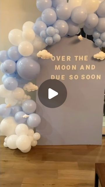 balloon arch with words over the moon and due so soon