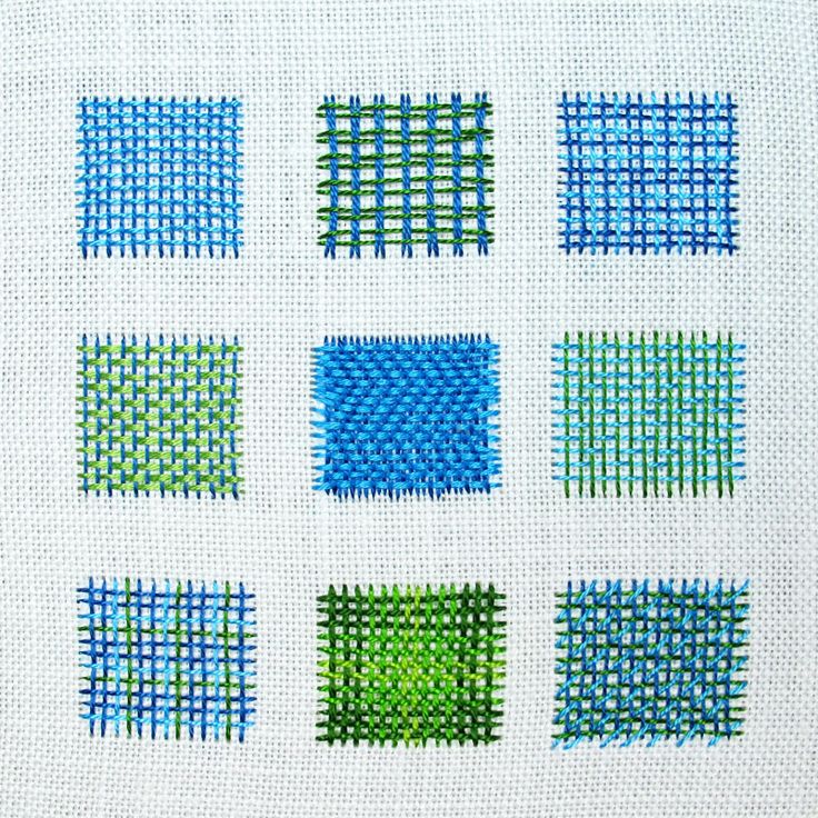 cross stitch squares in different colors on white fabric with green and blue stitches, all arranged in the same pattern