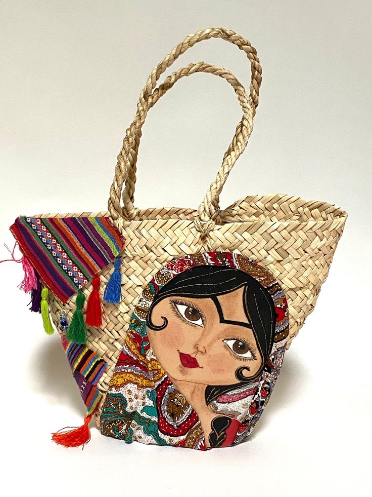 "A very unique small handmade straw bag with ethnic embroidery. The size: length at the opening 15\", height 11\", width 3\"" Artisan Embroidered Beach Bag, Bohemian Embroidered Straw Tote Bag, Bohemian Natural Embroidered Straw Bag, Handmade Multicolor Embroidered Shoulder Bag For Beach, Handmade Multicolor Embroidered Shoulder Bag For Vacation, Handmade Multicolor Embroidery Bags For Vacation, Handmade Multicolor Embroidered Bags For Vacation, Beach Shoulder Bag With Multicolor Embroidery, Bohemian Straw Bag With Woven Details