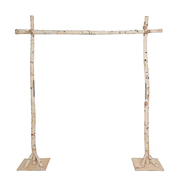 two wooden crosses are standing next to each other on metal bases, one is made out of birch and the other is painted white