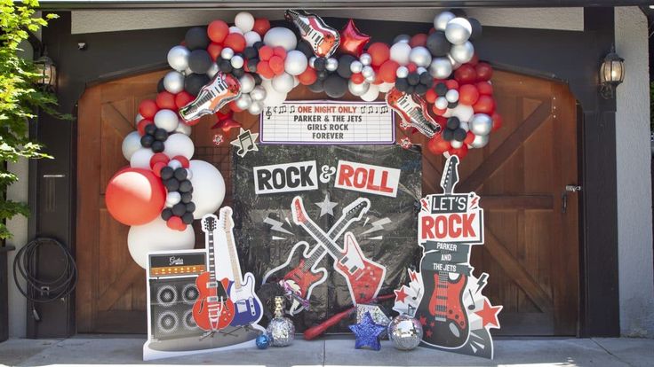 a rock and roll birthday party with balloons, streamers, and guitar decorations on the front door