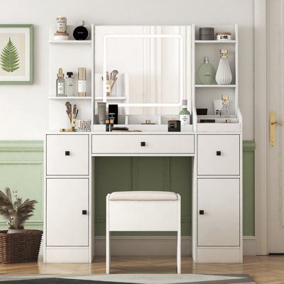 a white dressing table with a mirror, stool and shelves on the wall next to it