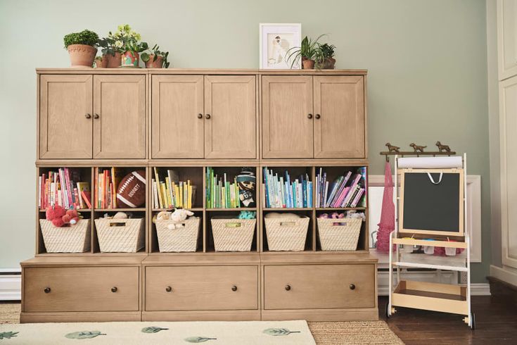 a wooden shelf filled with lots of books and pencils next to a white rug