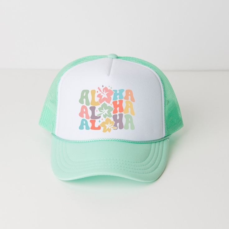 a green and white trucker hat with the words aloha in multicolored letters