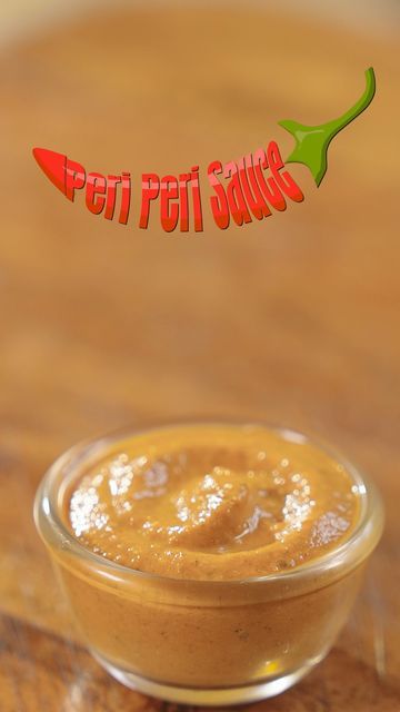 a small bowl filled with peanut butter on top of a wooden table next to a sign