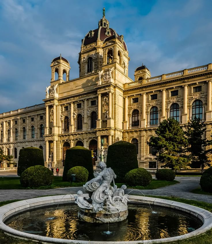 a large building with a fountain in front of it