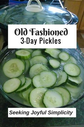 a bowl filled with sliced cucumbers on top of a counter next to a sign that says old fashioned 3 - day pickles