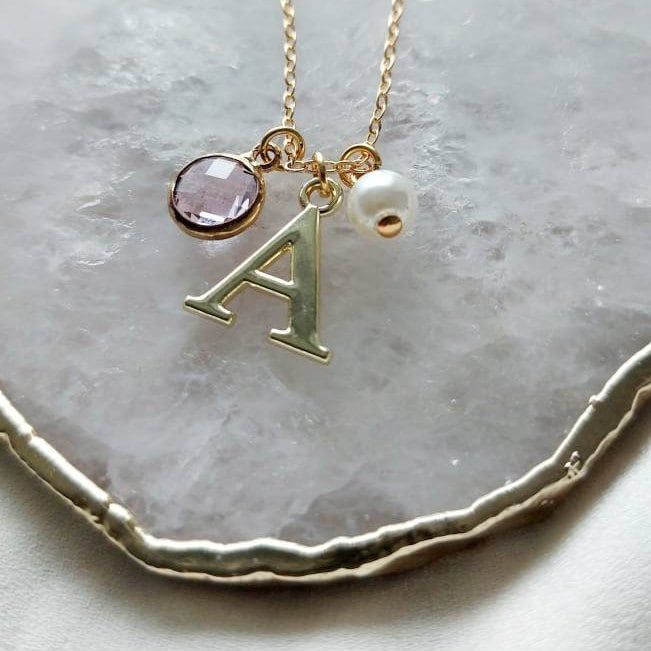 Darling necklace with a gorgeous crystal, a faux pearl and a dainty gold tone letter charm. A personalized gift necklace makes the perfect gift for your Bridesmaids. All items come in a gift bag ready to give as a gift or keep for yourself! A beautiful necklace to layer with other favourites. Choose your initial and birthstone from the drop-down box, choose the letter and crystal colour. January: Garnet (Red) February: Amethyst (Purple) March: Aquamarine (Bluey Green)  April: Diamond (Clear) May Elegant Gold Birthstone Necklace For Personalized Gift, Gold Custom Name Charm Necklace For Wedding, Elegant Birthstone Necklace With Charms For Personalized Gift, Gold Charm Necklace With Custom Name For Wedding, Gold Name Necklace With Birthstone For Wedding, Elegant Personalized Charm Necklace For Bridesmaids, Gold Initial Pendant Birthstone Necklace For Personalized Gift, Gold Birthstone Necklace With Initial Pendant For Personalized Gift, Dainty Gold Birthstone Necklace With Initials