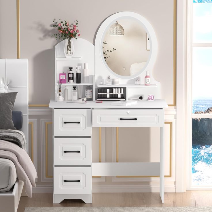 a white vanity with drawers and a mirror on the wall in a bedroom next to a bed