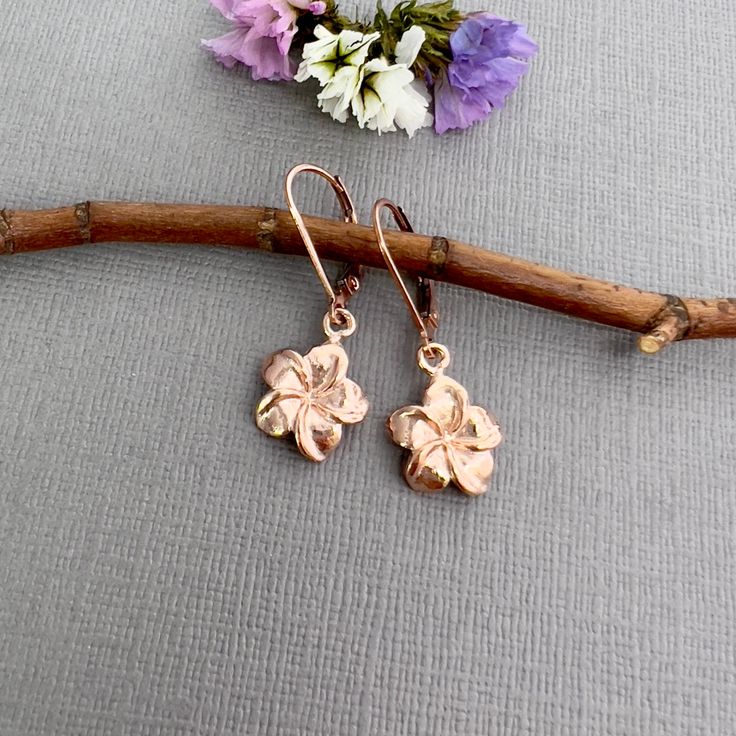 "✦Plumeria flower charms are cast from sterling silver and dipped in 18k rose gold and dangle from 18k rose gold vermeil ear wires.   The flowers measure about 12mm in diameter (about 1/2 inch) and have a total length of about 1-1/4\".  So light weight and easy to wear.  Each earring comes with a hypoallergenic rubber grommet to hold the ear wire securely in place. ✦Matching necklace available: https://www.etsy.com/listing/573410054 ✦Earrings also available in sterling silver https://www.etsy.com/listing/575871060 and yellow gold https://www.etsy.com/listing/593064511. ✦Your jewelry will be packaged in a beautiful and reusable organza bag. All items will be placed in the same organza bag. If you need a separate bag for each item, please leave a comment at check out. ✦Giving your purchase a Rose Gold Dangle Jewelry For Mother's Day, Delicate Rose Gold Jewelry As Gift For Mom, Delicate Rose Gold Jewelry For Mom, Everyday Rose Gold Flower Charm Jewelry, Everyday Rose Gold Jewelry With Flower Charm, Dainty Pink Gold Flower Jewelry, Pink Gold Flower Shaped Jewelry Gift, Everyday Rose Gold Jewelry With Birth Flower, Pink Gold Flower-shaped Jewelry Gift