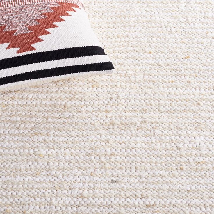 an area rug with black and white stripes on the bottom, red and white stripe down the middle