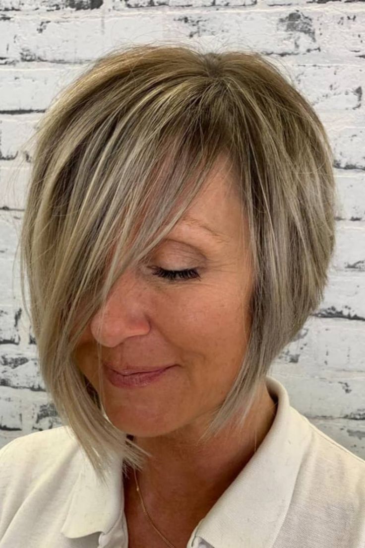 asymmetrical-haircut-great-for-over-50-women Blonde Hair Over 50, Sleek Haircuts, Short Asymmetrical Haircut, Asymmetrical Bob Short, Fine Thick Hair, Asymmetrical Haircut, 60s Hair, Long Face Shapes, Timeless Looks