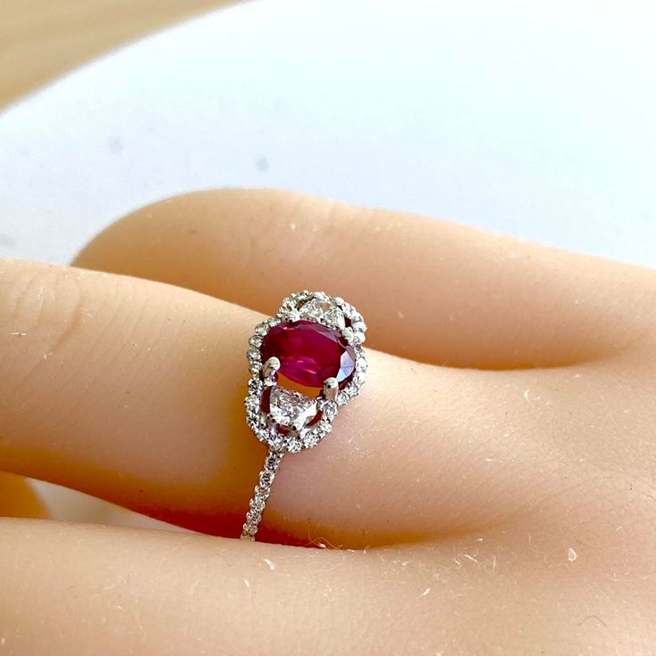 Introducing our exquisite Oval Burma Ruby Half Moon Diamonds Ring, a stunning piece crafted with precision and elegance. This timeless creation is set in luxurious Eighteen Karat White Gold, ensuring a perfect blend of sophistication and durability. Finger size 6 The centerpiece of this captivating ring is a luscious Oval Burma Ruby, weighing 1.05 carat, boasting a vibrant red hue that symbolizes passion and strength. Mined from the renowned Burmese mines, this ruby is not only a statement of beauty but also a testament to its exceptional quality. Flanking the resplendent ruby are two Half Moon Diamonds, weighing total of 0.30 carats, each meticulously cut to enhance their brilliance and sparkle. Pave set diamonds, weighing 0.90 carats, complement the ruby perfectly, adding a touch of glam Luxury Oval Ruby Diamond Ring, Luxury Platinum Ruby Ring, Luxury Ruby Gemstone Ring In Platinum, Oval Ruby Ring In Platinum For Formal Occasions, Formal Oval Ruby Ring In Platinum, Luxury Diamond Ruby Ring, Luxury Ruby Ring With Diamonds, Luxury Oval Ruby Ring With Prong Setting, Luxury Oval Ruby Ring