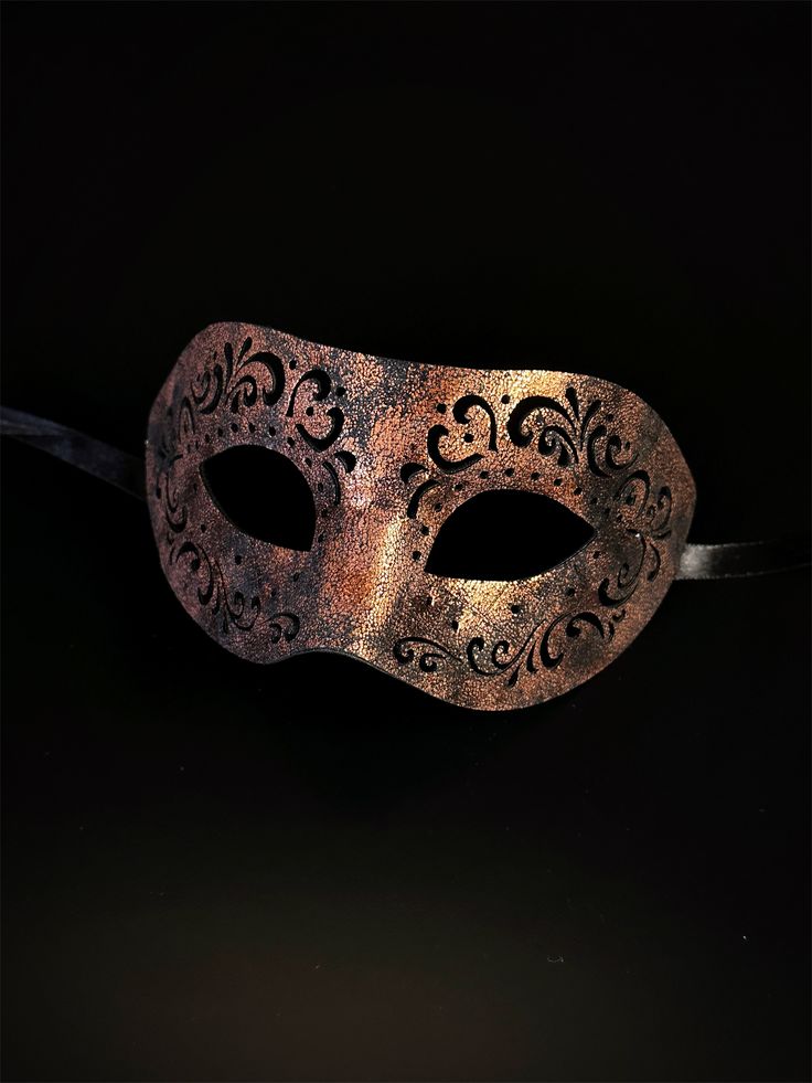 Crafted with intricate engraved patterns on soft vegan leather, this mask is a masterpiece of artistry that adds an air of mystique to your masquerade ensemble. Embrace the allure of engraved elegance and captivate hearts with your enigmatic presence at masquerades and special events! Age Group/Gender - Adult/Men Size/Type - One size fits all adults Mask Color - Copper Mask Material - Vegan Leather Nature Masquerade Mask, Venetian Formal Eye Mask, Elegant Eye Mask For Theater, Formal Venetian Eye Mask For Masquerade, Elegant Theater Eye Mask, Venetian Style Formal Eye Masquerade Mask, Vintage Eye Mask For Parties, Vintage Eye Mask For Party, Vintage Masquerade Eye Mask