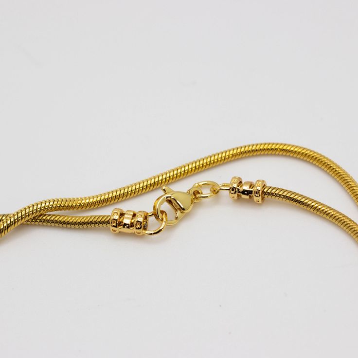 Classic snake chain 18k heavy gold plated stainless steel 5mm width *Gold-filled jewelry is jewelry composed of a solid layer of gold (typically constituting at least 5% of the item's total weight) mechanically bonded to a base alloy). Which means like solid gold, this piece is tarnish resistant, fade resistant and water resistant. The stainless steel chain has a thick gold plated layer that will keep your neck from turning green. Yellow Gold Snake Chain Necklace, Gift Tarnish Resistant Snake Chain Necklace, Gold Plated Tarnish Resistant Snake Chain Necklace, Gold-plated Tarnish Resistant Snake Chain Necklace, Gold-plated Tarnish-resistant Snake Chain Necklace, Yellow Gold Snake Chain Necklace With Adjustable Chain, Tarnish Resistant Gold Plated Snake Chain Necklace, Gold Tarnish Resistant Snake Chain Necklace Gift, Gold-tone Snake Chain Necklace