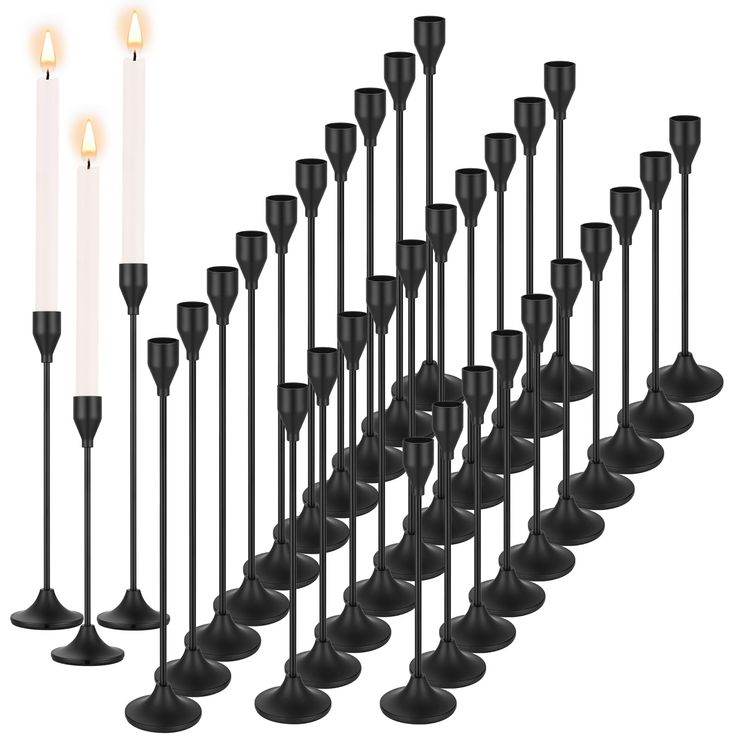 a number of black candles on a white background