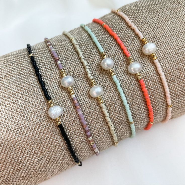 "Add a little Boho Chic to your everyday look with our latest pearl accent beaded bracelets.  Pair them with other bead bracelets, your favorite gold or silver bracelets, or even your watch for the stack of the season. Details:  Miyuki Glass Beads, Freshwater Pearl, Nylon Cord Bracelets expand from 6\" to 10\" A little bit about us: Mom-owned Business Sourcing only the highest quality materials Quick shipping from Colorado" Adjustable Beads With Pearl Charm, Elegant Tiny Beads Friendship Bracelets For Beach, Minimalist Pearl Bracelet With Tiny Round Beads, Dainty Pearl Beaded Bracelets With Round Beads, Beaded Bracelet With Pearl Charm As Gift, Adjustable Pearl Bracelet With Colorful Beads, Pearl Beaded Bracelets For Beach With Tiny Beads, Beach Pearl Beaded Bracelets With Tiny Beads, Gift Beaded Bracelet With Pearl Charm