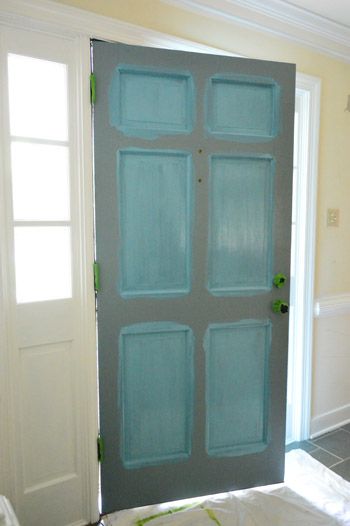 an open door in the middle of a room with white walls and tile flooring