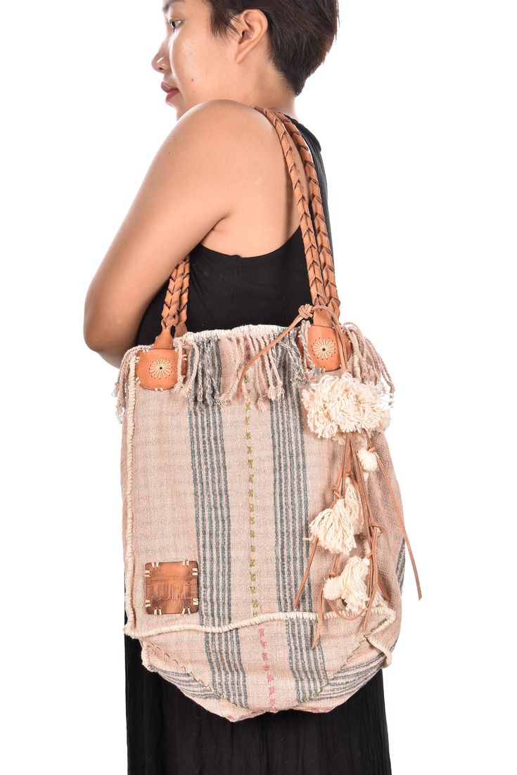 "Pink striped cotton handbag, ethnic boho style, natural dye soft cotton, leather handles, tribal hand stitching BG23 Video showing the bag in action: https://youtu.be/Gr1oWtXr2xY Pale pink with gray-blue stripes and green/pink/cream accents... Each Bending Gems bag is unique and one-of-a-kind. This bag is hand constructed using fabric by the Karen or Karian ethnic group of Thailand and Burma. This fabric is hand woven on a traditional, back-strap loom with cotton colored using natural, organic, Cotton Handbag, Boho Throws, Hand Wax, Natural Dye, Leather Handles, Vegetable Tanned Leather, Natural Dyes, Leather Handle, Boho Style