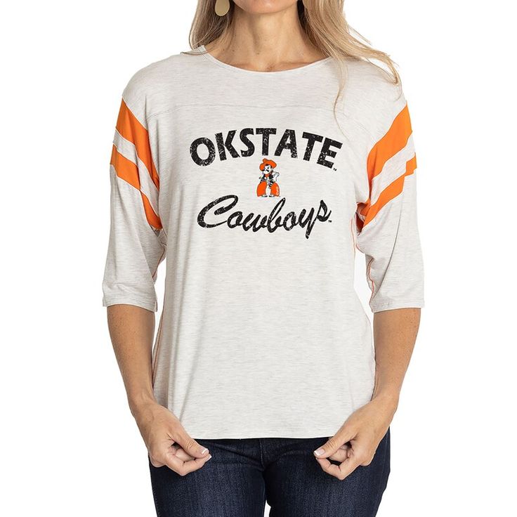 Elevate the style of your game day tee with this Oklahoma State Cowboys Sabrina Jersey T-shirt. It features the team name and logo accentuated by contrast-color side stitching and sleeve stripes. A rounded hem gives this Oklahoma State Cowboys shirt a more comfortable fit and feel. Collegiate Game Day T-shirt With Team Name, Varsity T-shirt For College Football Season, Varsity Jersey Tops For Fan Gear, Varsity Logo Print T-shirt For Game Day, Jersey Tops For Game Day, Sports Fan Style, Jersey Sports Fan Top For Game Day, Jersey Material Sports Fan Top For Game Day, Varsity Jersey T-shirt For Baseball Season, Casual Jersey T-shirt For Game Day