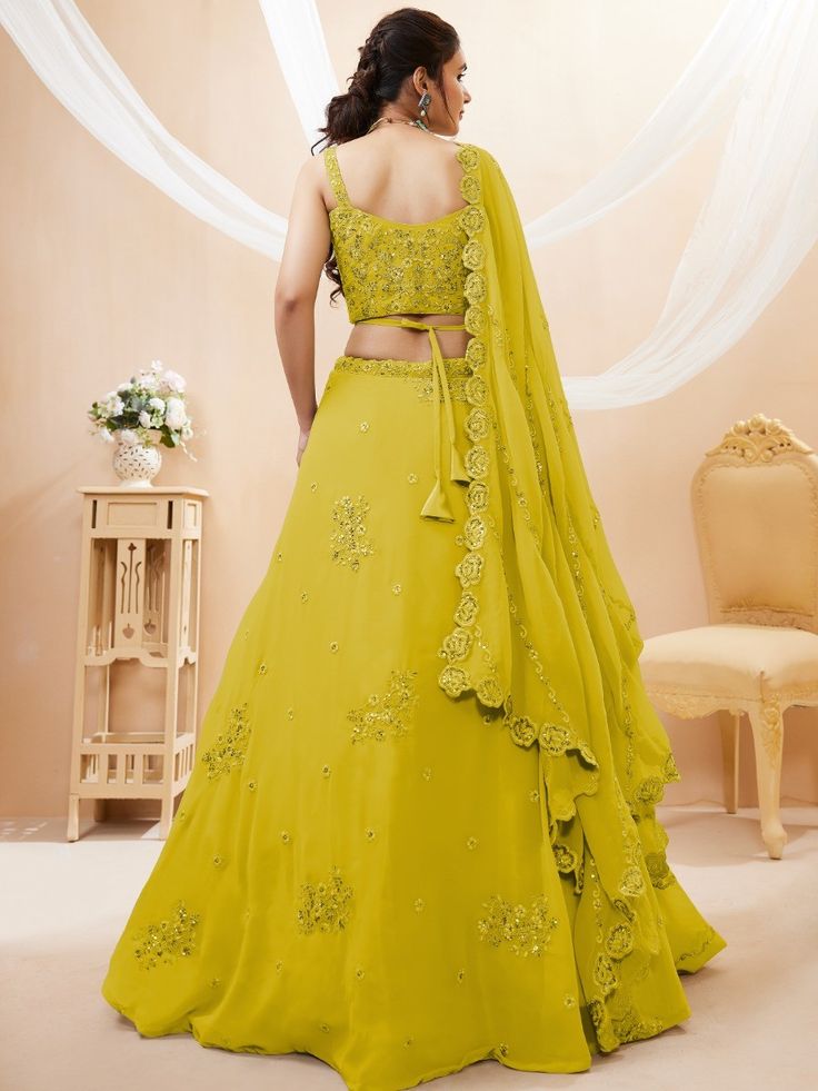 Introducing our adorable neon yellow sequins georgette wedding wear lehenga choli, a vibrant and stylish outfit that is perfect for any special occasion. This exquisite piece is made from high-quality georgette material in a stunning neon yellow color. It features intricate dori work, glitter sequin work, and embroidery work, adding a touch of elegance and glamour to the ensemble.
The set includes a matching georgette choli that is adorned with the same dori work, glitter sequin work, and embroi Pista Green Embellished Lehenga For Party, Embellished Pista Green Lehenga For Party, Yellow Chinon Sets For Wedding, Party Embellished Pista Green Lehenga, Party Wear Embellished Georgette Lehenga, Embellished Party Wear Lehenga In Georgette, Embellished Georgette Lehenga For Party, Pista Green Embellished Party Choli, Yellow Georgette Choli For Navratri