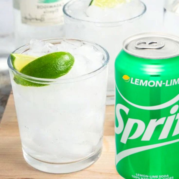 a can of sprite lemon lime soda next to a glass