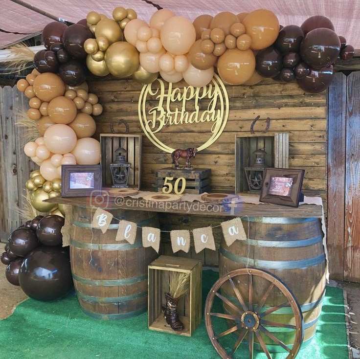 a birthday party with balloons and decorations on the wall, including an old fashioned wagon