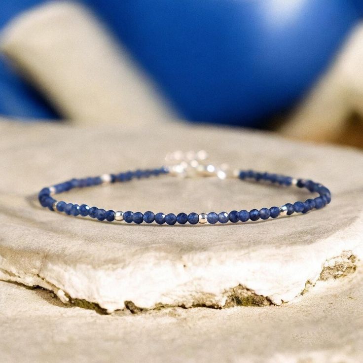 This sapphire bracelet is a stunning accessory that will brighten up your wrist and your mood. It is handmade with high-quality elastic cord and has a comfortable fit. It measures about 6.5 inches in length and can be adjusted to fit most wrists. The bracelet is easy to wear and take off. This bracelet is perfect for anyone who loves boho chic style, natural stones. It is a unique and meaningful gift for yourself or someone special. You can wear it alone or stack it with other bracelets for a layered look. - Made to Order - Material : Natural Sapphire - Bracelet Length: fit for 6 ~ 7.5 inches wrist, adjustable - Hand Woven Bracelet with Love and Sincerity - Due to different light and screen, the color may be slightly different from the picture. - Every natural stone is measured by hand, th Dainty Blue Stackable Bracelets, Minimalist Blue Hypoallergenic Bracelets, Adjustable Faceted Sapphire Bracelets, Adjustable Faceted Sapphire Bracelet, Blue Gemstone Beads Minimalist Bracelets, Dainty Blue Bracelets With Natural Stones, Minimalist Blue Gemstone Bead Bracelets, Dainty Blue Gemstone Beaded Bracelets, Blue Dainty Gemstone Beaded Bracelet