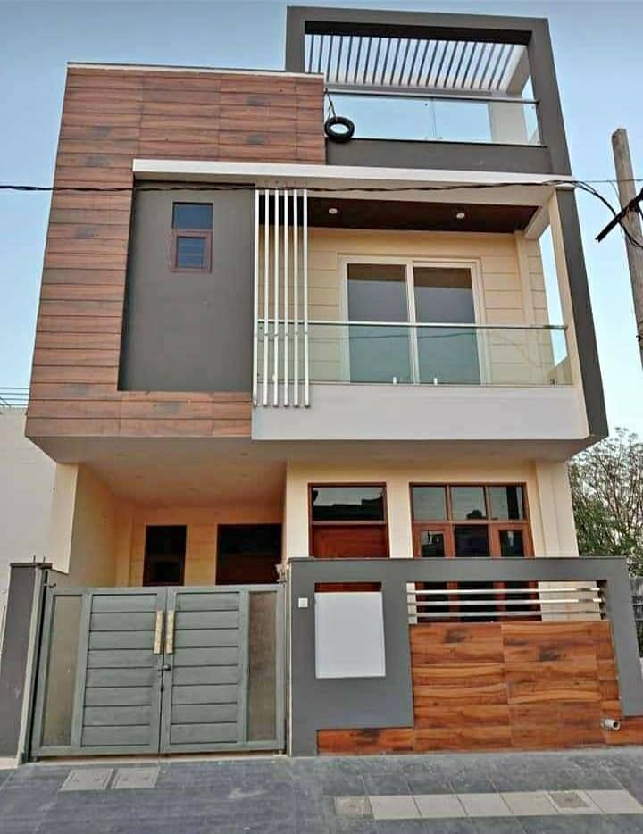 a two story house with wooden and metal railings