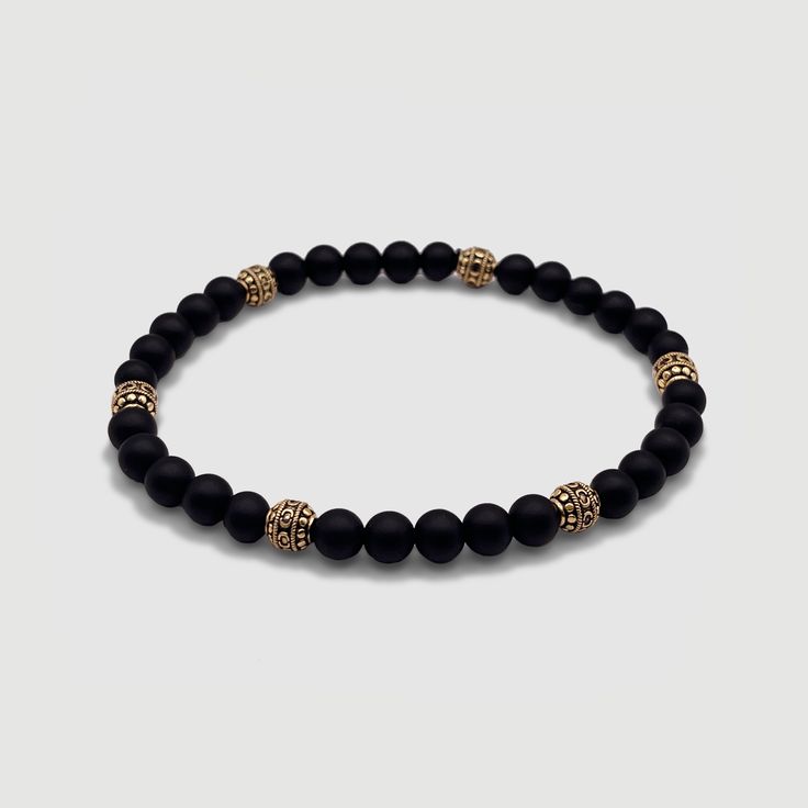 Effortless style is good manners. CRAFTD for individuality, every semi-precious Onyx stone displays its own unique markings, resulting in a truly one-of-a-kind piece. Enhanced with 18K gold beads, its relaxed aesthetic becomes the ideal companion for those essential laid-back days. Qualities: Sharpened Focus ✓ Semi-Precious Onyx Stone✓ 18K Gold & 316L Stainless Steel ✓ Water, Heat, Sweat Resistant Model is 5'11 & Wears Size 19cm. Elegant Gemstone Beads Crystal Bangle Bracelet, Elegant Crystal Gemstone Beads Bangle Bracelet, Elegant Crystal Bangle Bracelet With Gemstone Beads, Elegant Bracelets With Natural Round Beads, Elegant Beaded Bracelets With Natural Stones, Elegant Round Crystal Bracelet With Gemstone Beads, Elegant Rosary Bracelet With Natural Stones, Adjustable Gemstone Beads Rondelle Bracelets, Classic Onyx Jewelry With Gemstone Beads