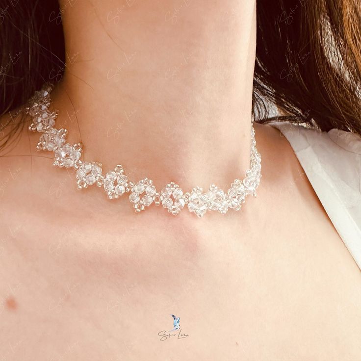 This white crystal bead choker is perfect for cocktail party outfit, wedding party, features shiny white bead with adjustable chain. Add this white rhinestone choker to your everyday fashion jewelry collection or as gift for your love one. Choker length: 13 +2 inches Materials: beads Jewelry Care: See more information about how to care for your jewelry here. Shipping Policy: Orders will be shipped within 1-3 business days. Economy shipping will take 7-14 days to arrive and standard shipping is 1 Dainty Sparkling Necklace For Party, Crystal Pearl Necklace With Clavicle Chain, White Rhinestone Clavicle Chain Necklace For Party, Sparkling Rhinestone Choker Necklace For Gift, White Rhinestone Clavicle Necklace For Party, Sparkling Rhinestone Choker Necklace Gift, Crystal Clavicle Chain Choker For Party, Party Crystal Choker With Clavicle Chain, White Rhinestone Clavicle Necklace For Weddings