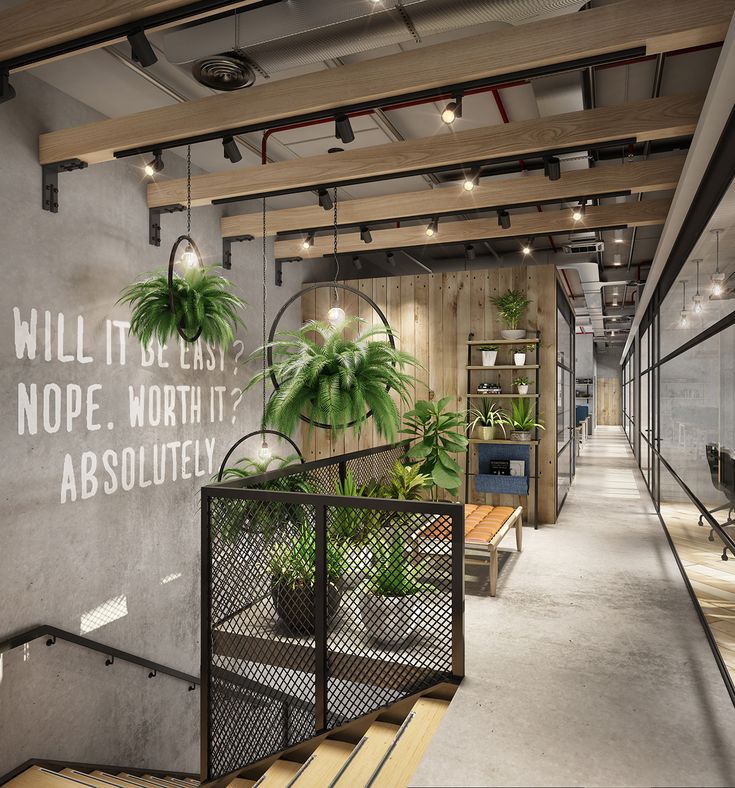 an office lobby with plants on the wall and wooden steps leading up to the second floor