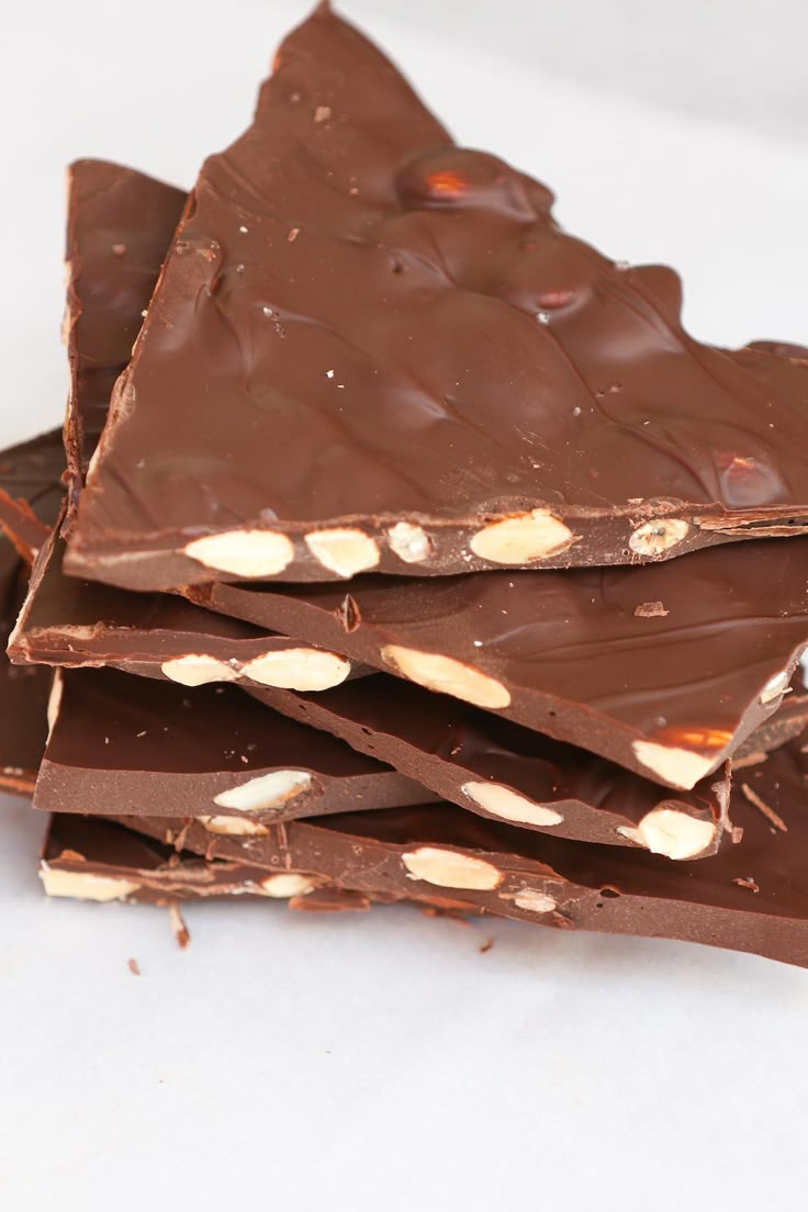 pieces of chocolate with peanut butter on top stacked up in the shape of a triangle