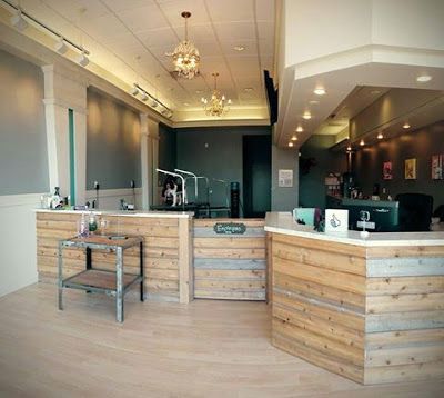 the interior of a dental office with wooden counter tops and chairs in front of it